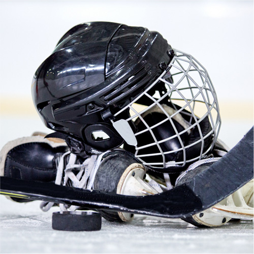hockey helmet, puck, and part of a hockey stick